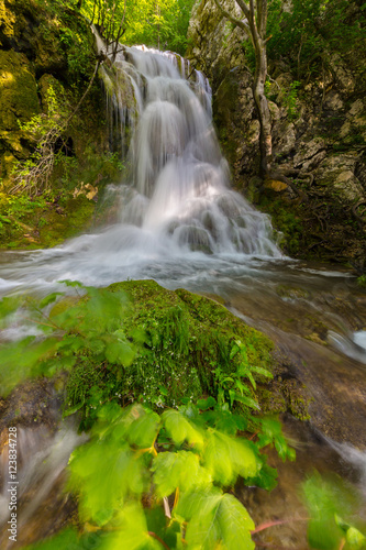 Pretty waterfalls deep in the woods  on a bright sunny day in spring