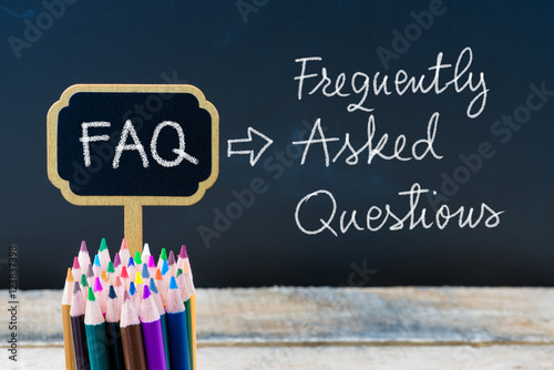 Business Acronym FAQ Frequently Asked Questions written with chalk on wooden mini blackboard labels