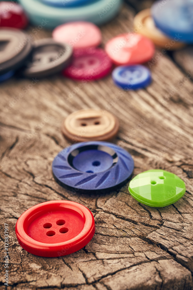 Buttons on wooden background Buttons on wooden background