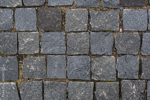 Abstract background of old cobblestone pavement close-up.