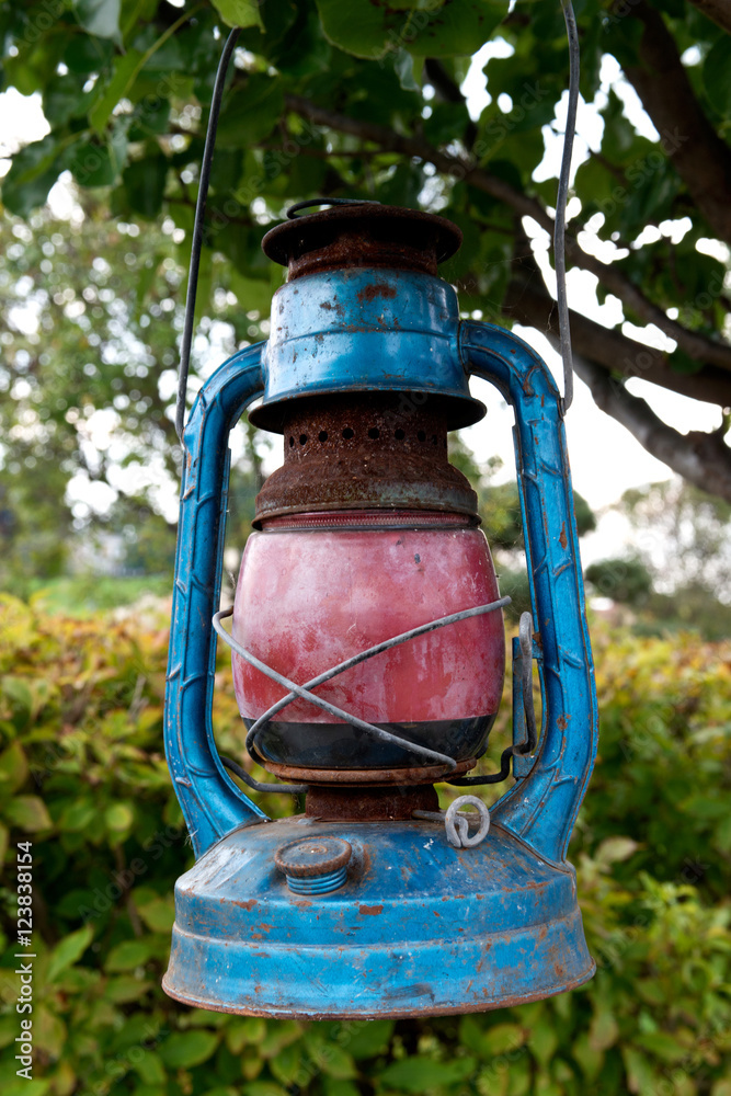 Antique rusty petroleum lamp in the garden