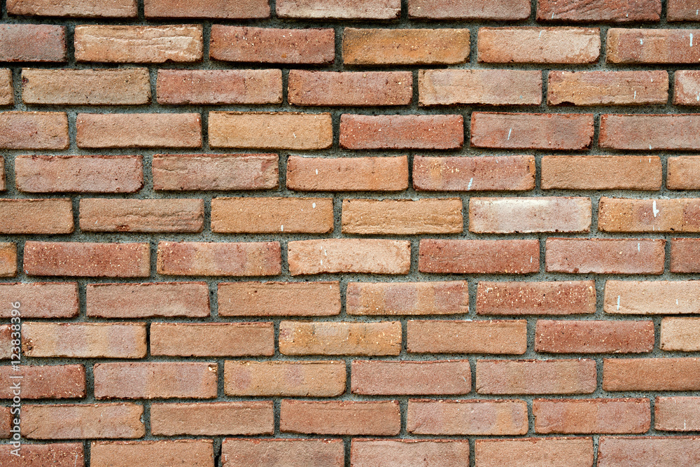 Fototapeta premium Red brick wall in the sun background