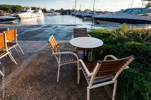 Cafe near the marina with yachts  at sunset  Greece