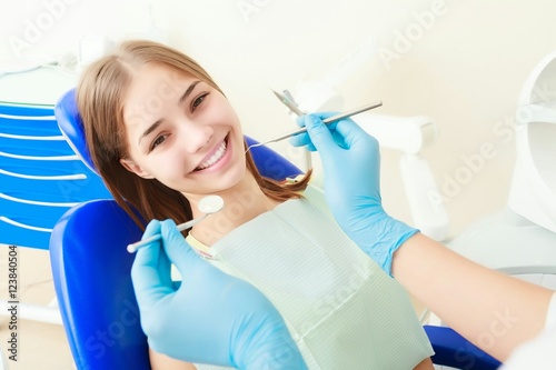 Young female sitting in dentist office