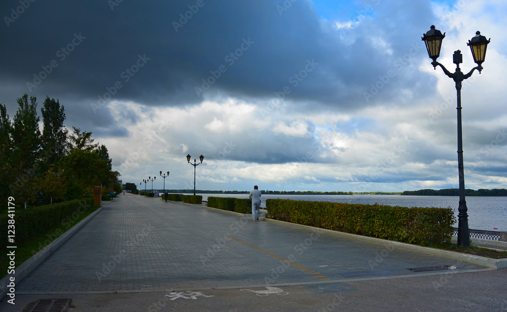 View on the Volga quay of the Samara city in anticipation of thunderstorm. City embankment before rain at cloudy autumn day