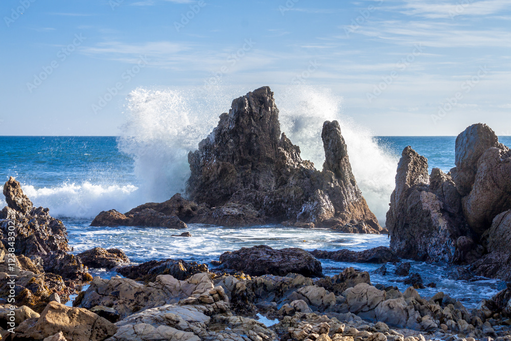 Wave crashing on rocks Corona Del Mar beach, Newport Beach California Wave crashing on rocks Corona Del Mar beach, Newport Beach California