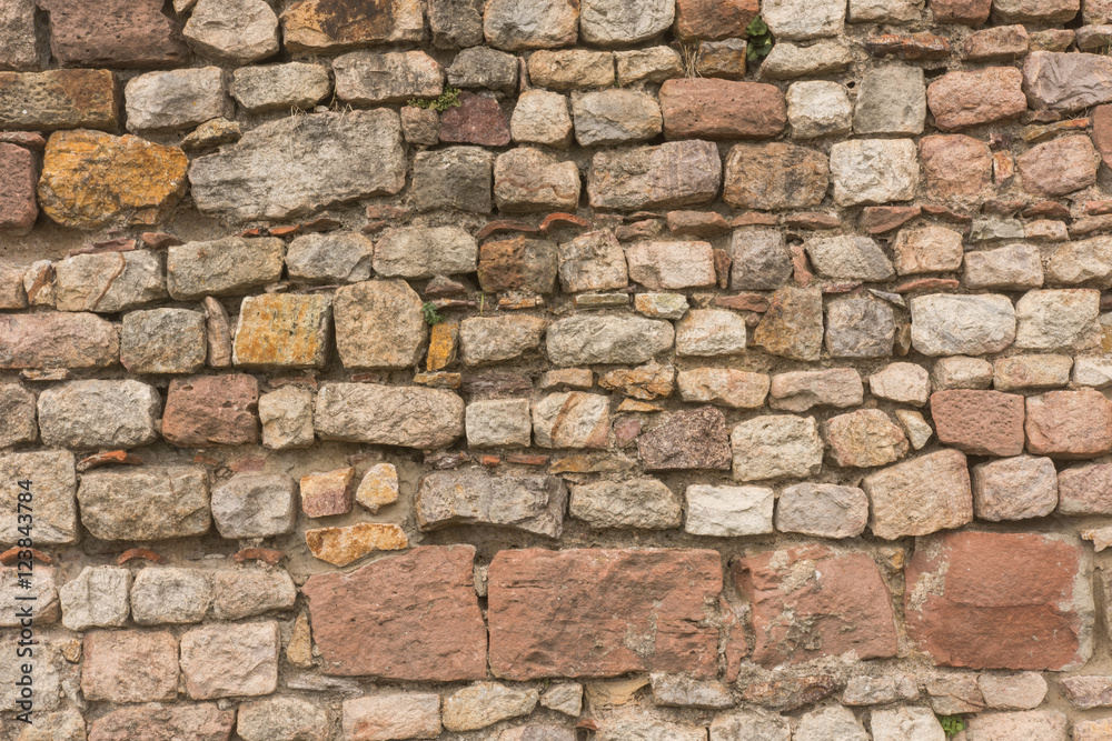 Naklejka premium Stone wall made out of single bricks