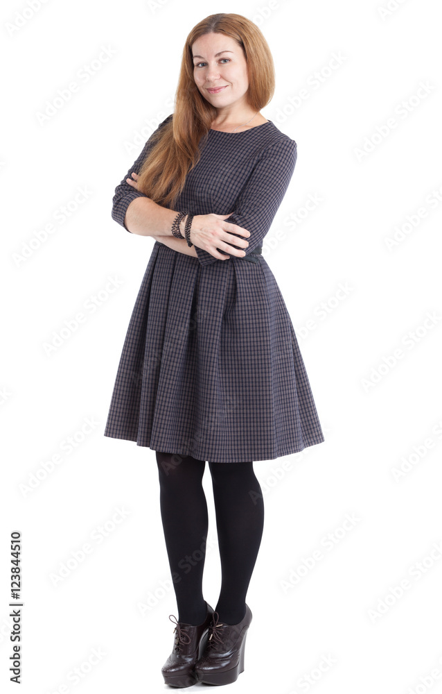 Pretty smiling woman in a dress and shoes on a high platform, isolated white background