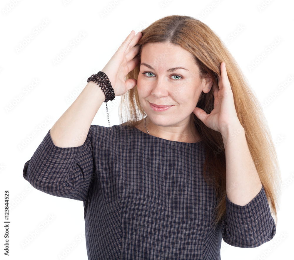 Woman wearing a dress corrects her long hair, isolated on white background Woman wearing a dress corrects her long hair, isolated on white background