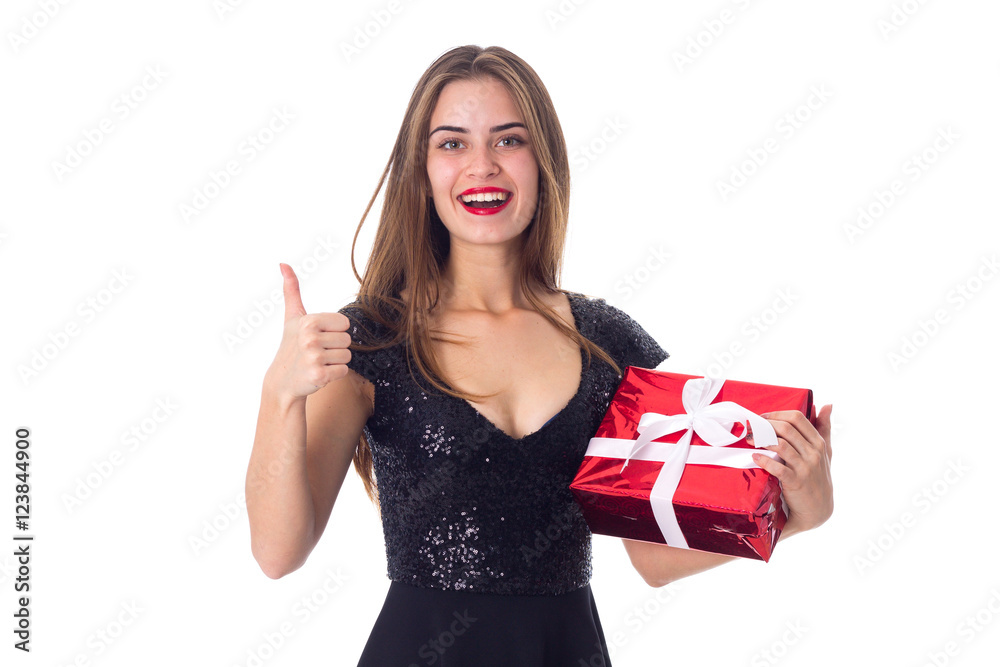 Woman holding a present and showing thumb up Woman holding a present and showing thumb up