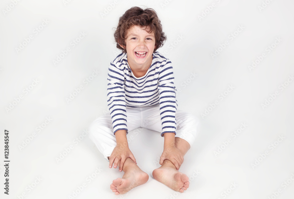 Cute and funny little boy in stripe shirt and white jeans Cute and funny little boy in stripe shirt and white jeans