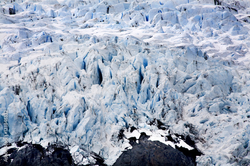 Blue Icy Portage Glacier with Rock and Crevaces Alaska photo