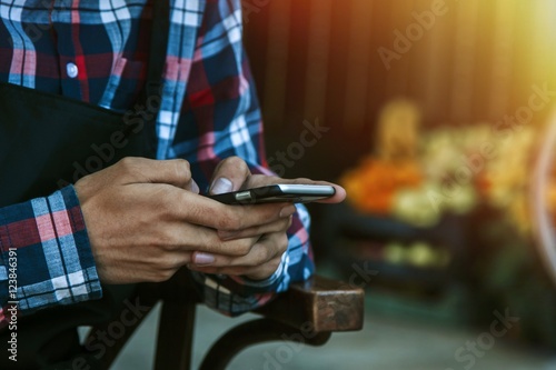 hands in the foreground with the mobile phone