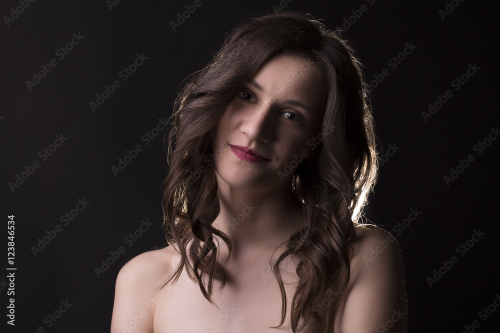 Smiling brunette model with naked shoulders
