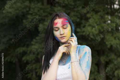 Brunette woman with color powder on her face