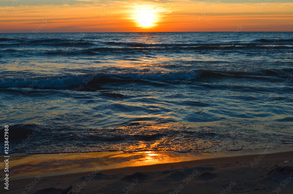 Brilliant sunrise over the waters of Lake Huron in Oscoda, Michigan