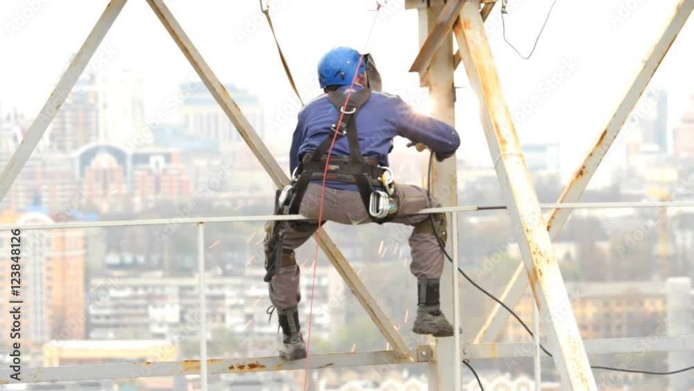Industrial Climber Works at a Height of Weld Design. Industrial Climber Works at a Height of Weld Design.