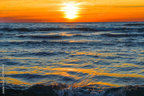 Brilliant sunrise over the waters of lake Huron in Oscoda, Michigan photo