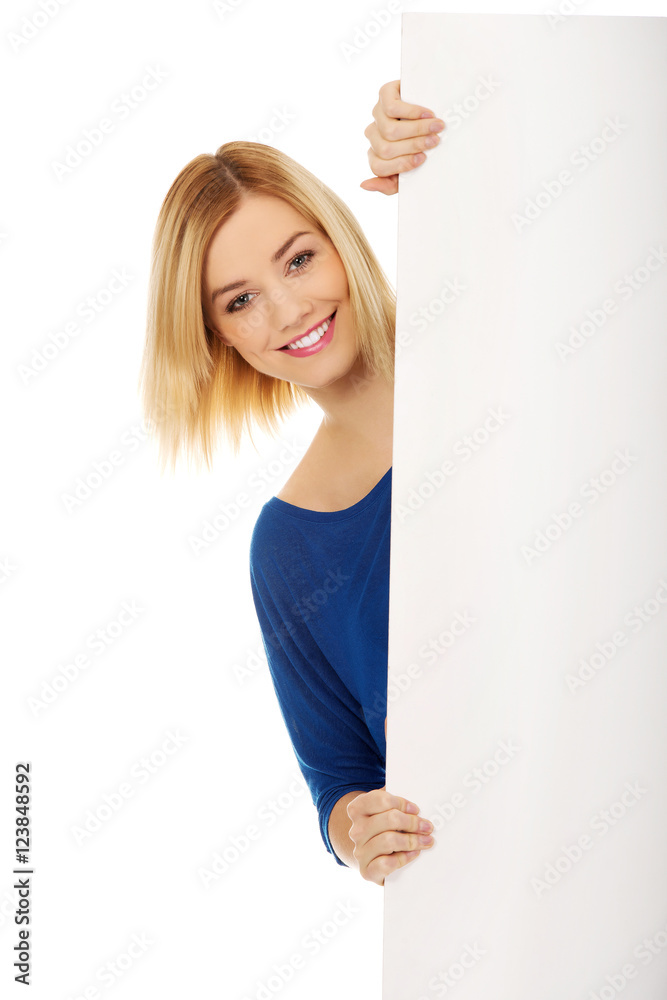 Happy young woman with blank billboard Happy young woman with blank billboard