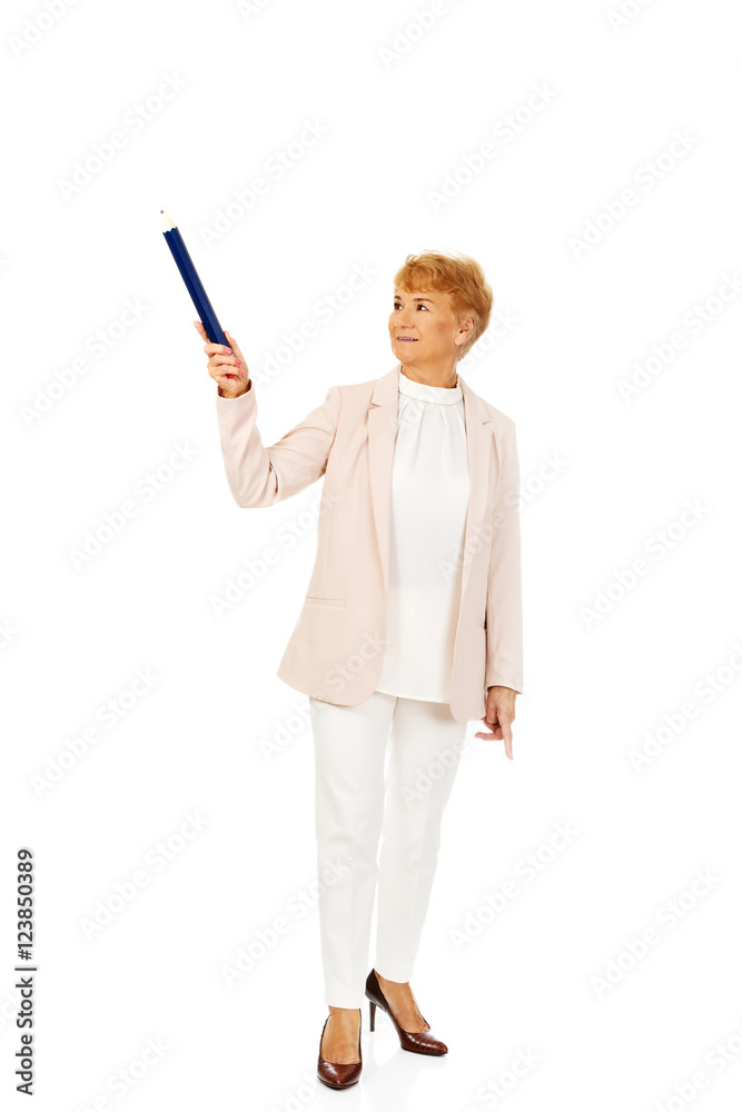 Smile elderly woman pointing up with hege pen Smile elderly woman pointing up with hege pen
