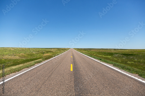 A road cutting through rolling hills in northern Nebraska on a summer day.   © harmantasdc