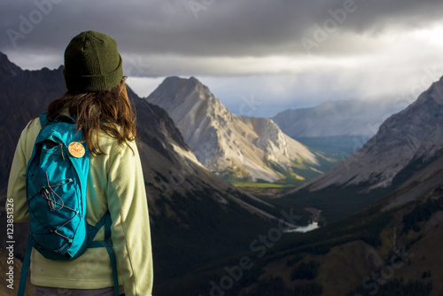 Brown haired girl looking out at mountains