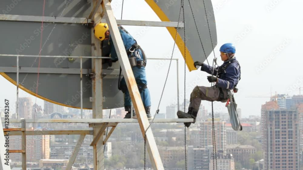 Industrial Climber Works at a Height of Weld Design.