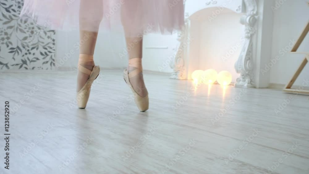 Close up of a ballet dancer's feet. Girl dancing in white room Close up of a ballet dancer's feet. Girl dancing in white room