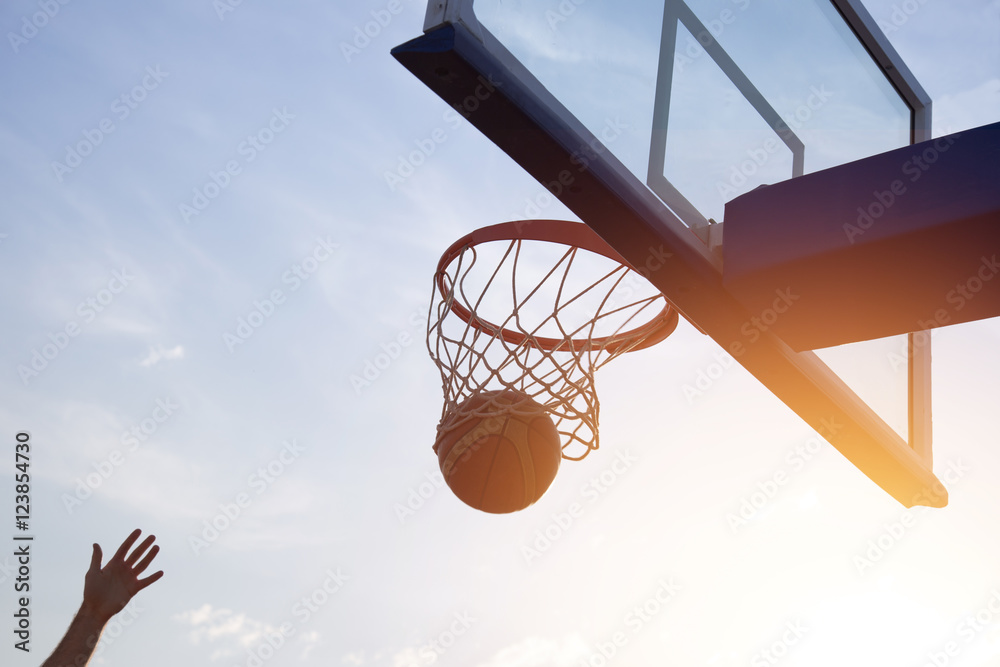 Fototapeta premium Basketball going through the basket
