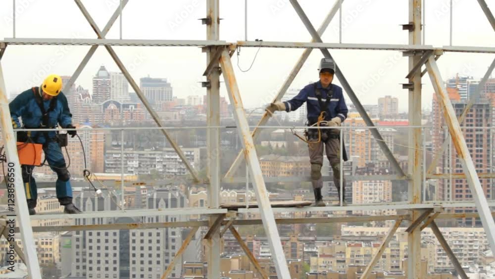 Industrial Climber Works at a Height of Weld Design. Industrial Climber Works at a Height of Weld Design.