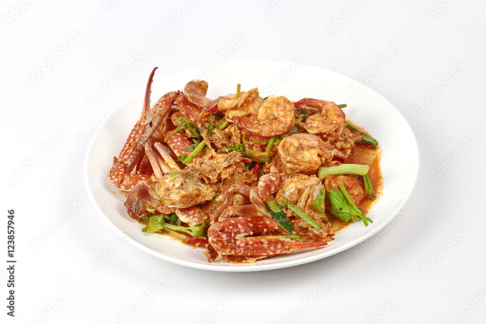 Stir-fried crab and shrimp in curry power is top-ten of popular Thai food as seafood to fried with fresh milk ,grill curry ,egg ,oyster oil and yellow curry power. Stir-fried crab and shrimp in curry power is top-ten of popular Thai food as seafood to fried with fresh milk ,grill curry ,egg ,oyster oil and yellow curry power.