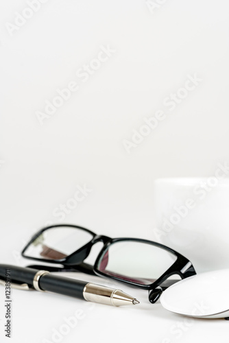 cup of coffee, pen, mouse and glasses, on a background