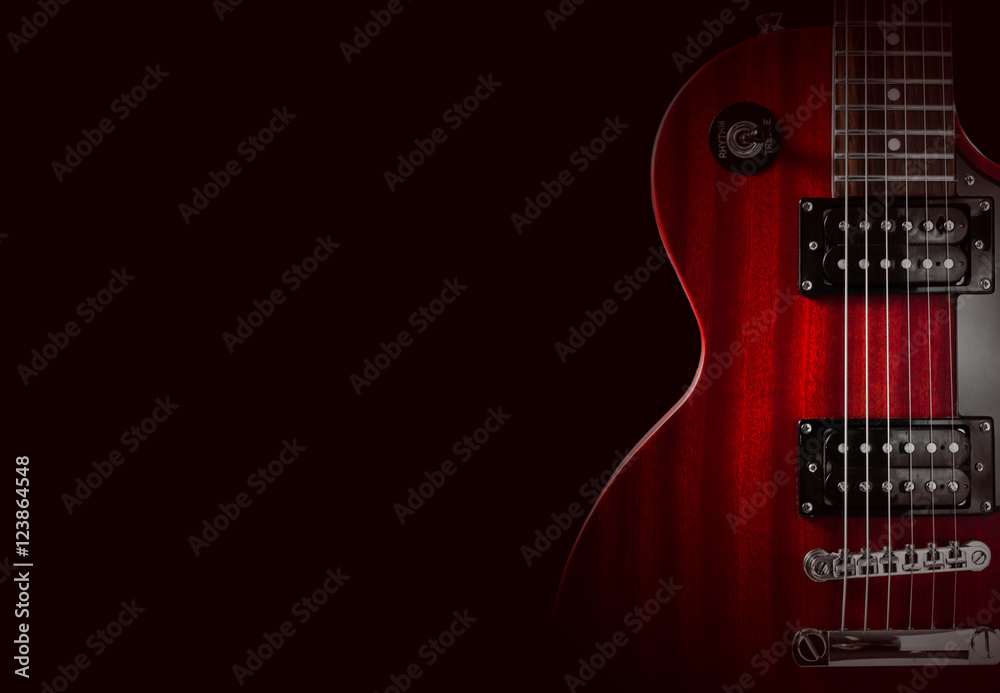 Part of the red electric guitar on black background. A place for writing of the text.