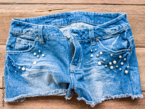Short jean on wood background
