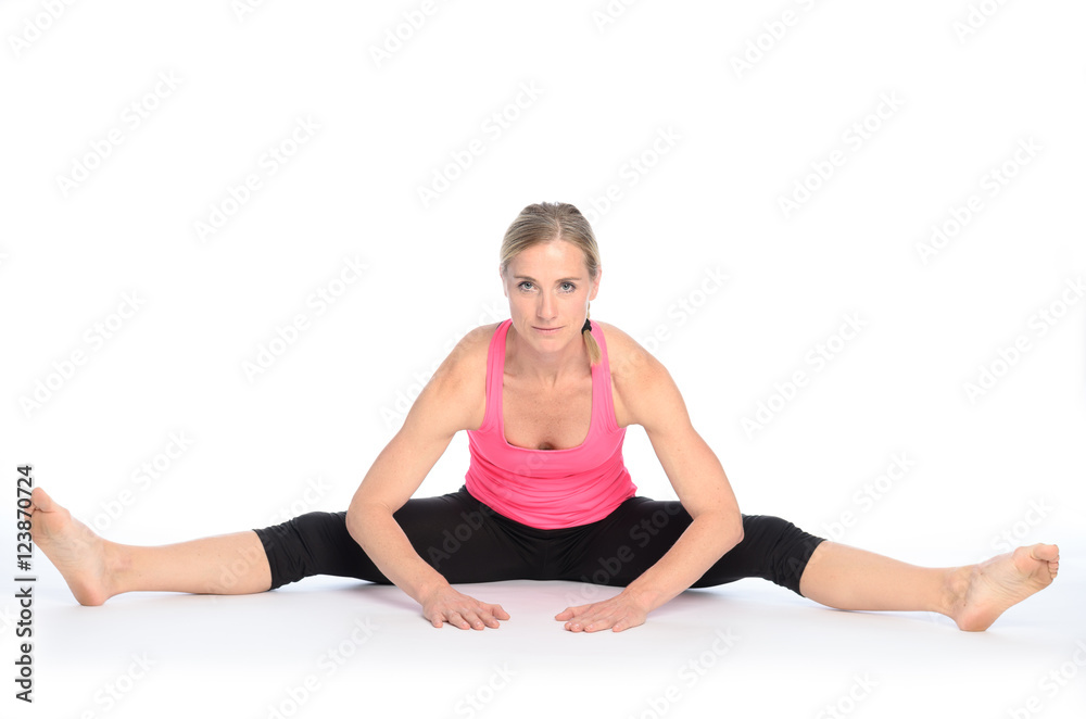 Young woman performing a straddle split stretch Young woman performing a straddle split stretch