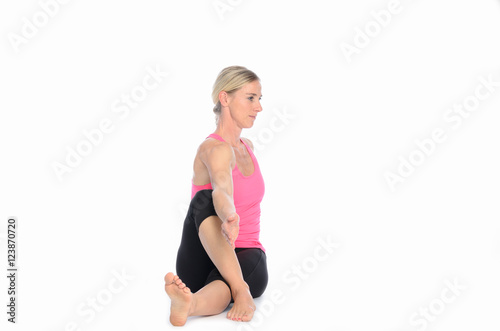 Woman twisting herself for a stretch