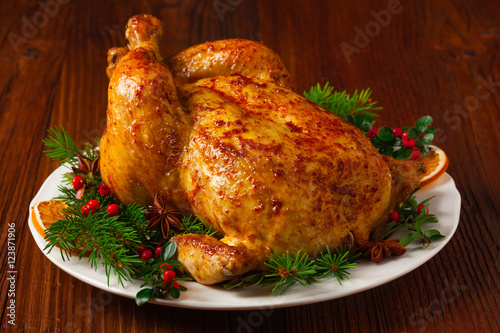 Roasted whole chicken with Christmas decoration.