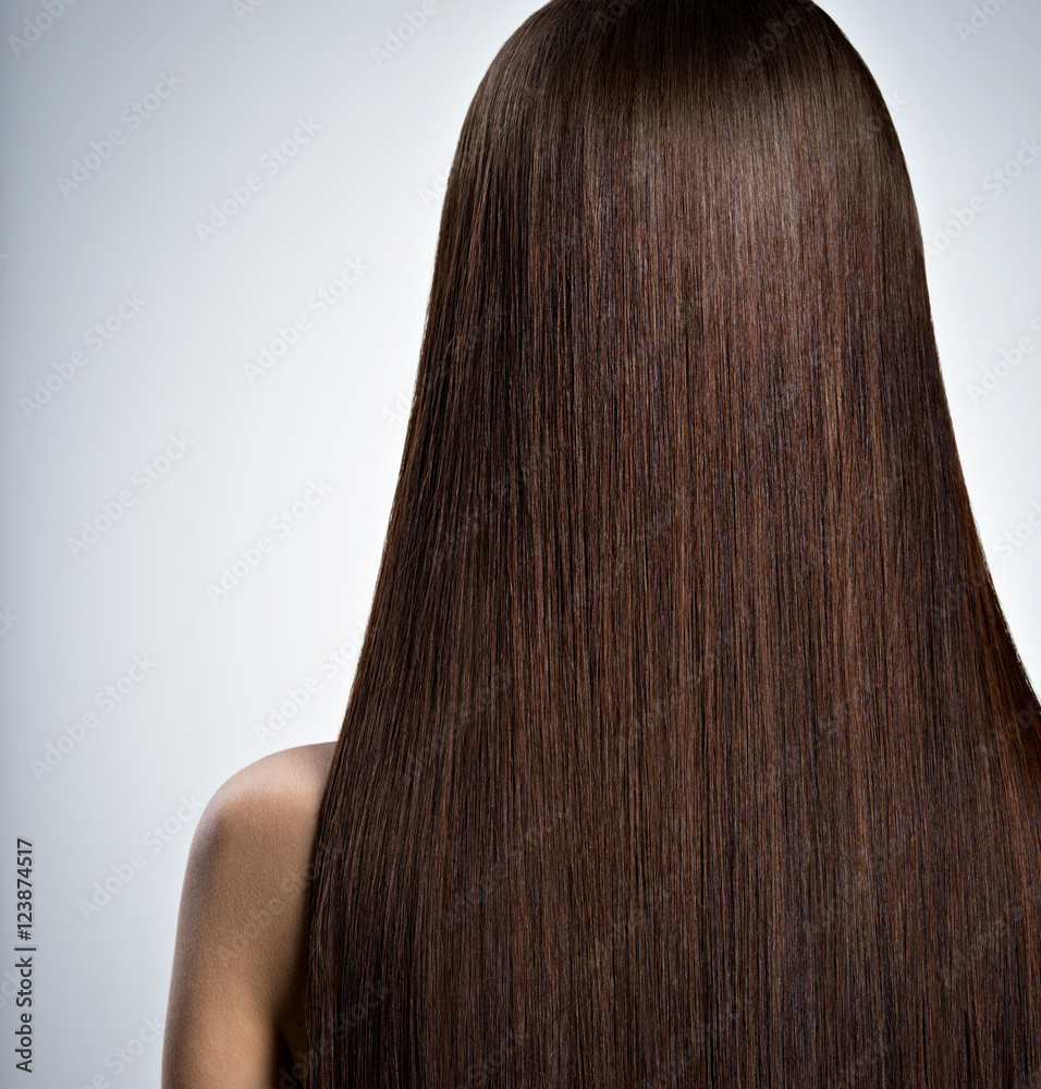 Woman with long brown straight hair. Rear view Woman with long brown straight hair. Rear view