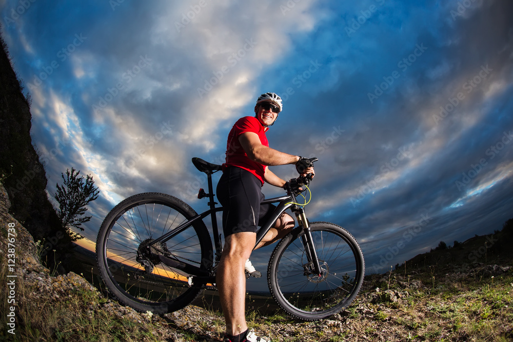 Fototapeta premium Man in helmet and glasses stay on the bicycle