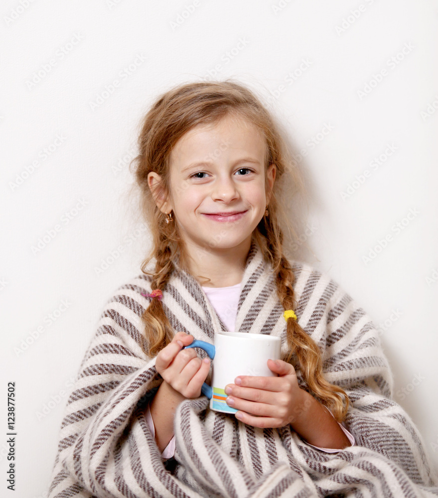 little girl smiling with a mug and a blanket little girl smiling with a mug and a blanket