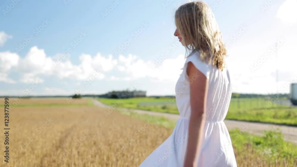 smiling young woman in white dress on cereal field smiling young woman in white dress on cereal field