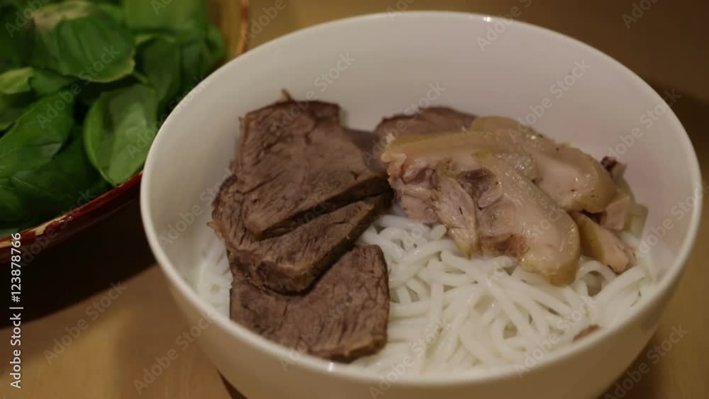 Chef prepare a bowl of traditional Vietnamese beef rice noodle, known as Bun Bo Hue. Chef prepare a bowl of traditional Vietnamese beef rice noodle, known as Bun Bo Hue.