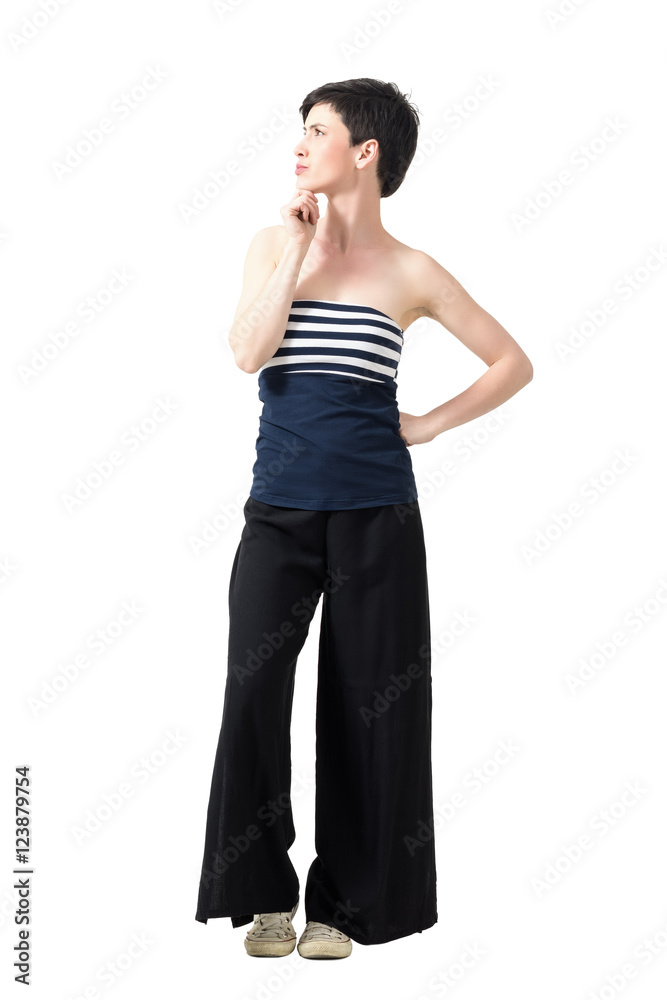 Profile view of young short hair pretty woman thinking and looking up with hand on chin. Full body length portrait isolated over white studio background. Profile view of young short hair pretty woman thinking and looking up with hand on chin. Full body length portrait isolated over white studio background.