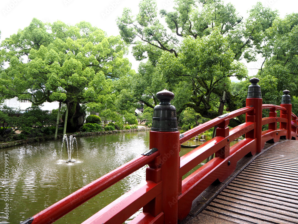 Red bridge at Dazaifu shrine in Fukuoka, Japan Red bridge at Dazaifu shrine in Fukuoka, Japan