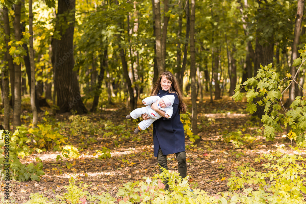 Beautiful Mother And Baby outdoors. Beauty Mum and her Child playing in Park together.
