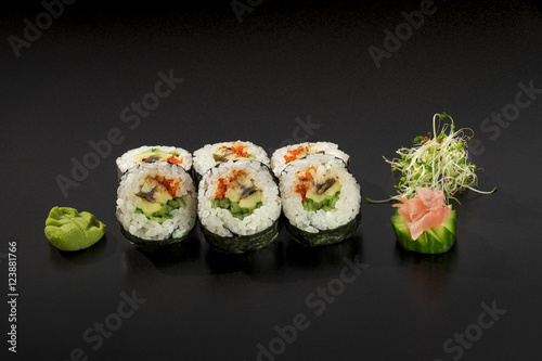 fresh made Japanese sushi rolls decorated with seaweed salad and