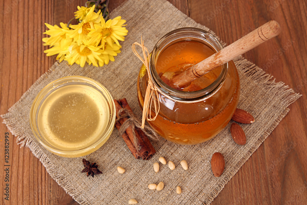 Delicious sweet honey with dipper in glass jar. Delicious sweet honey with dipper in glass jar.
