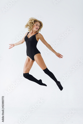 Studio shot of an attractive young woman dancing. Working on her technique