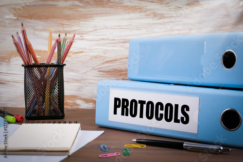 Protocols, Office Binder on Wooden Desk. On the table colored pe photo