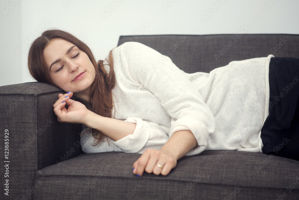 young woman lying on couch and is sleeping young woman lying on couch and is sleeping